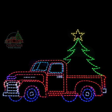 Decorative light display of a red truck with a Christmas tree on a black background.
