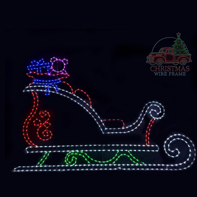 LED light display of a sleigh presents and teddy bear on a black background